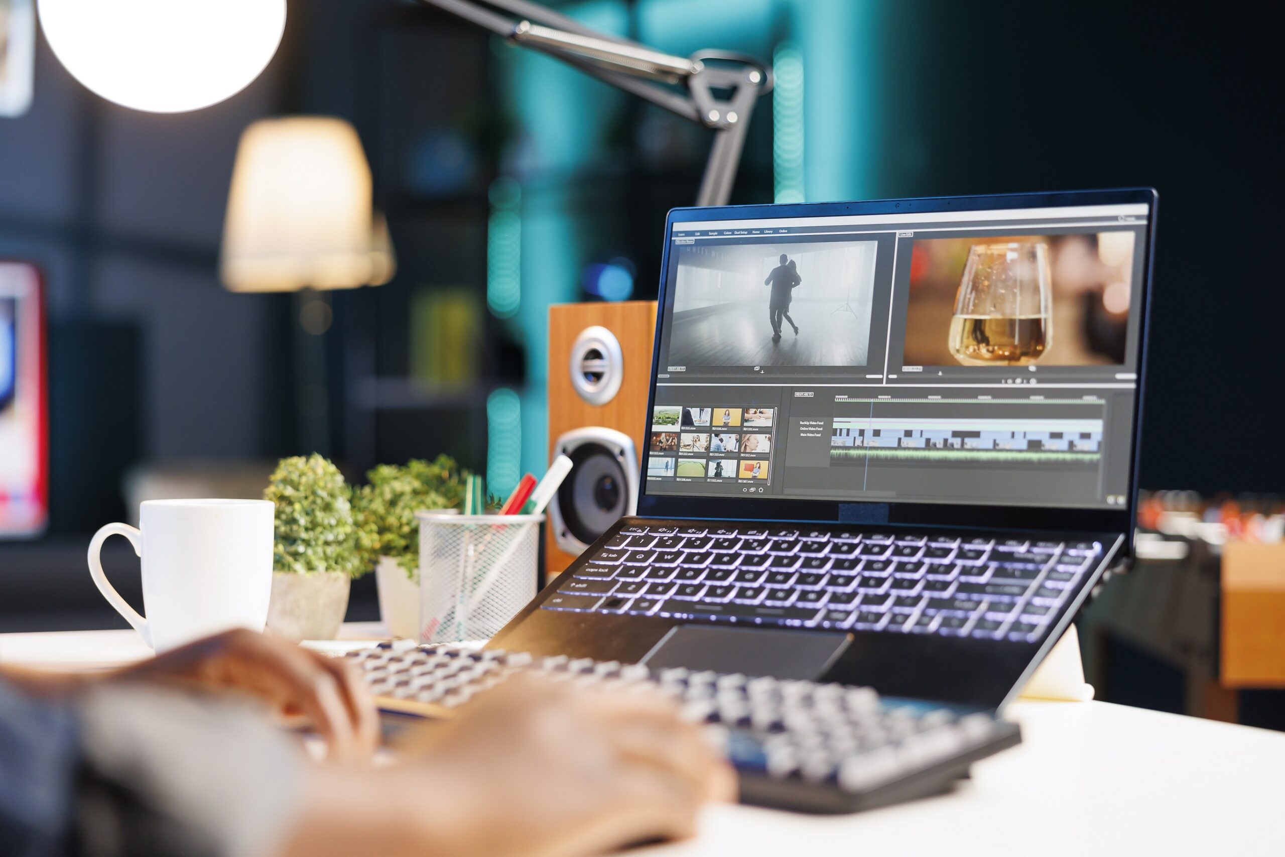 An individual edits film footage on digital laptop.